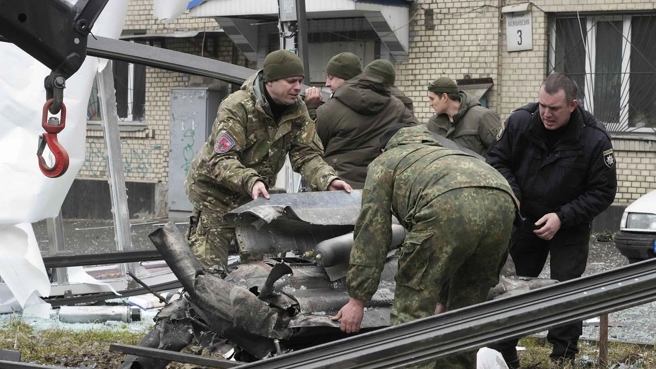 <div class="paragraphs"><p>Kyiv: Workers prepare to load the debris of a rocket onto a truck the aftermath of Russian shelling in Kyiv, Ukraine</p></div>