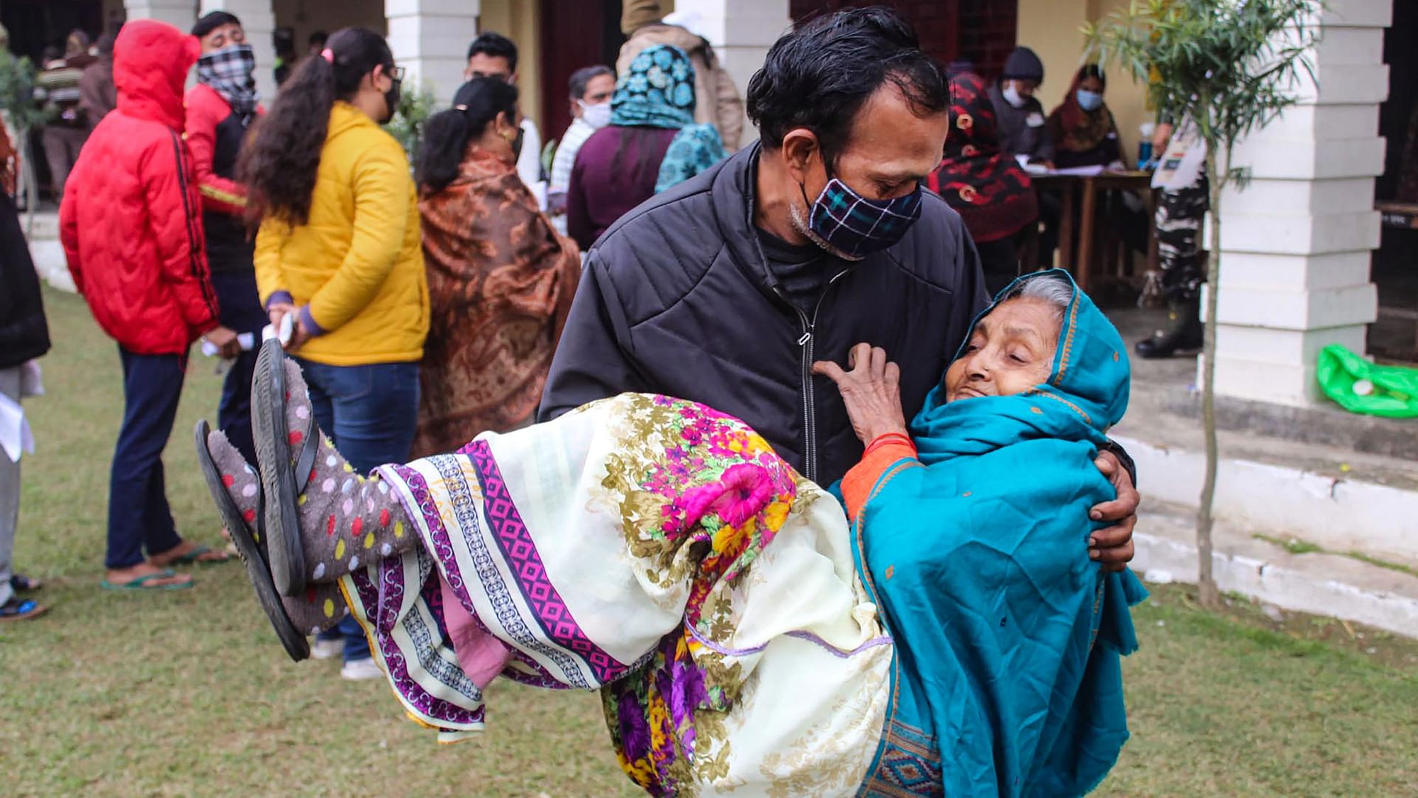 <div class="paragraphs"><p>Meerut: A man carries his elderly mother in his lap after she cast her vote at a polling station, during the first phase of UP Assembly elections, in Meerut, Thursday, 10 February)</p></div>