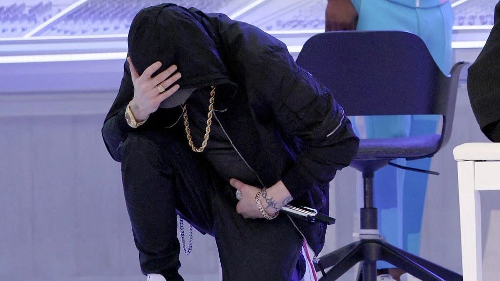 <div class="paragraphs"><p>Rapper Eminem takes the knee during his performance at the Super Bowl halftime.</p></div>