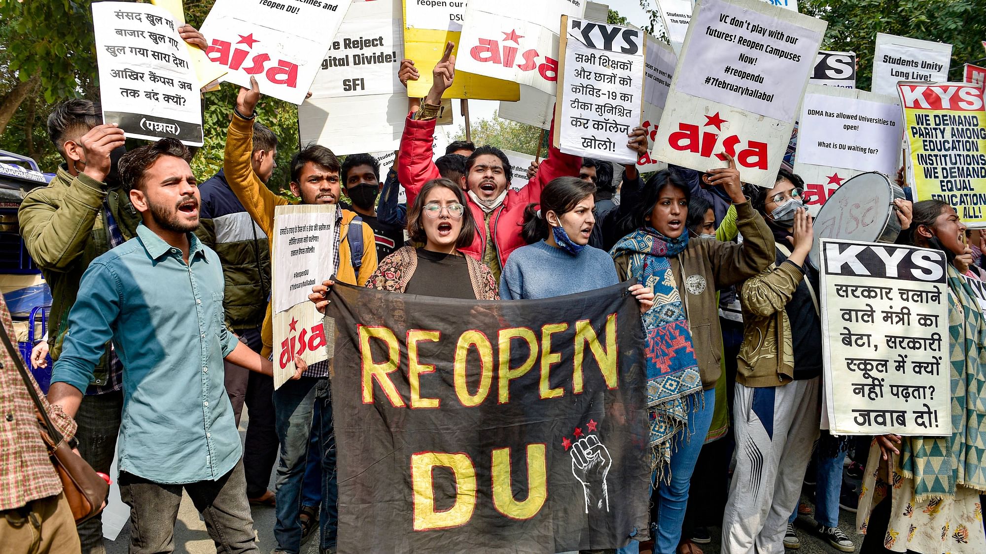 <div class="paragraphs"><p>Members of various student organisations hold placards as they stage a protest demanding reopening of the Delhi University, outside Arts Faculty in New Delhi, Tuesday.</p></div>