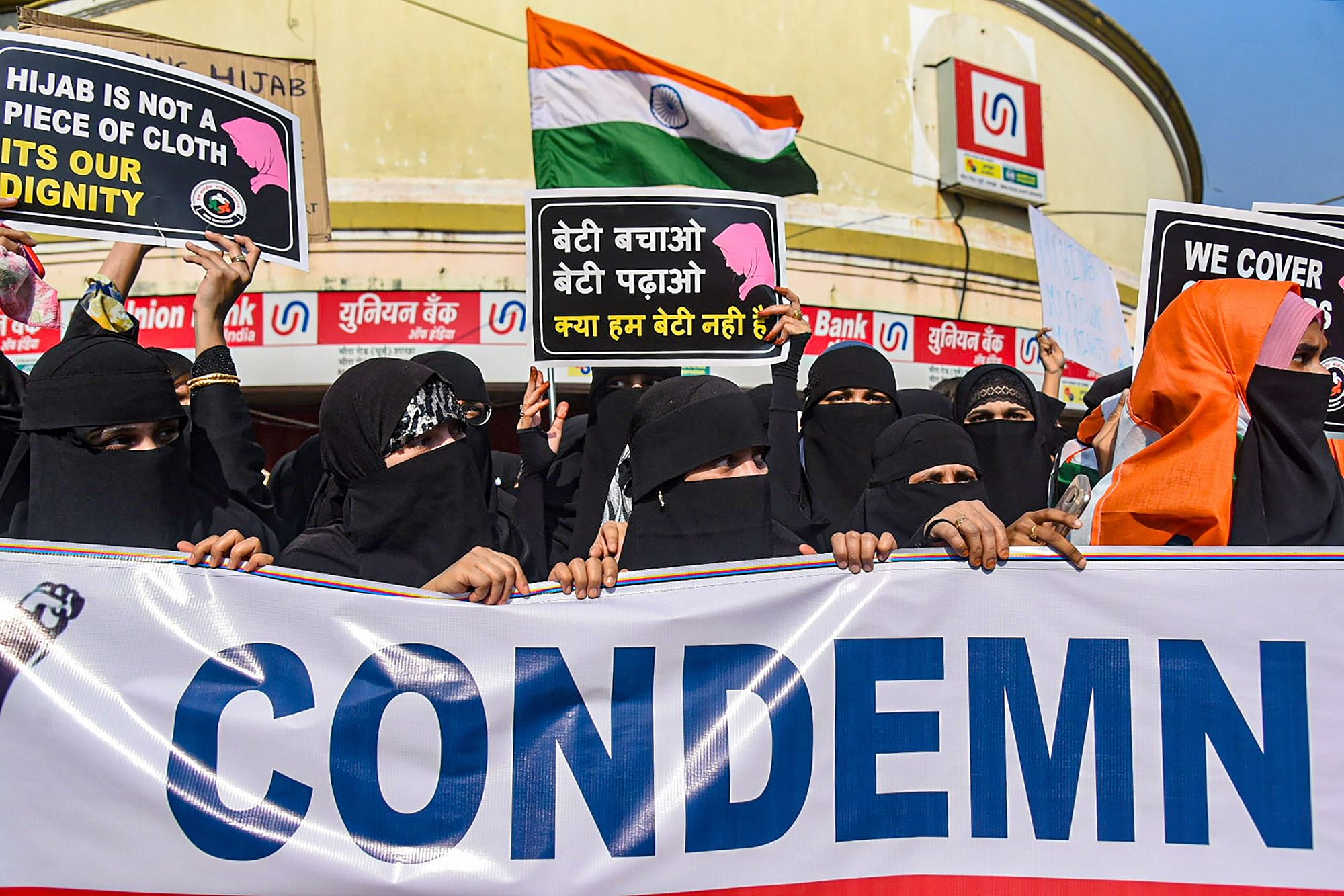 <div class="paragraphs"><p>Thane: Muslim women hold placards while wearing burqa and hijab to stage a demonstration in support of Muslim girl students, in Thane, Friday, 11 February. Muslim students were allegedly barred from attending classes while wearing hijab in various educational institutes in Karnataka.</p></div>