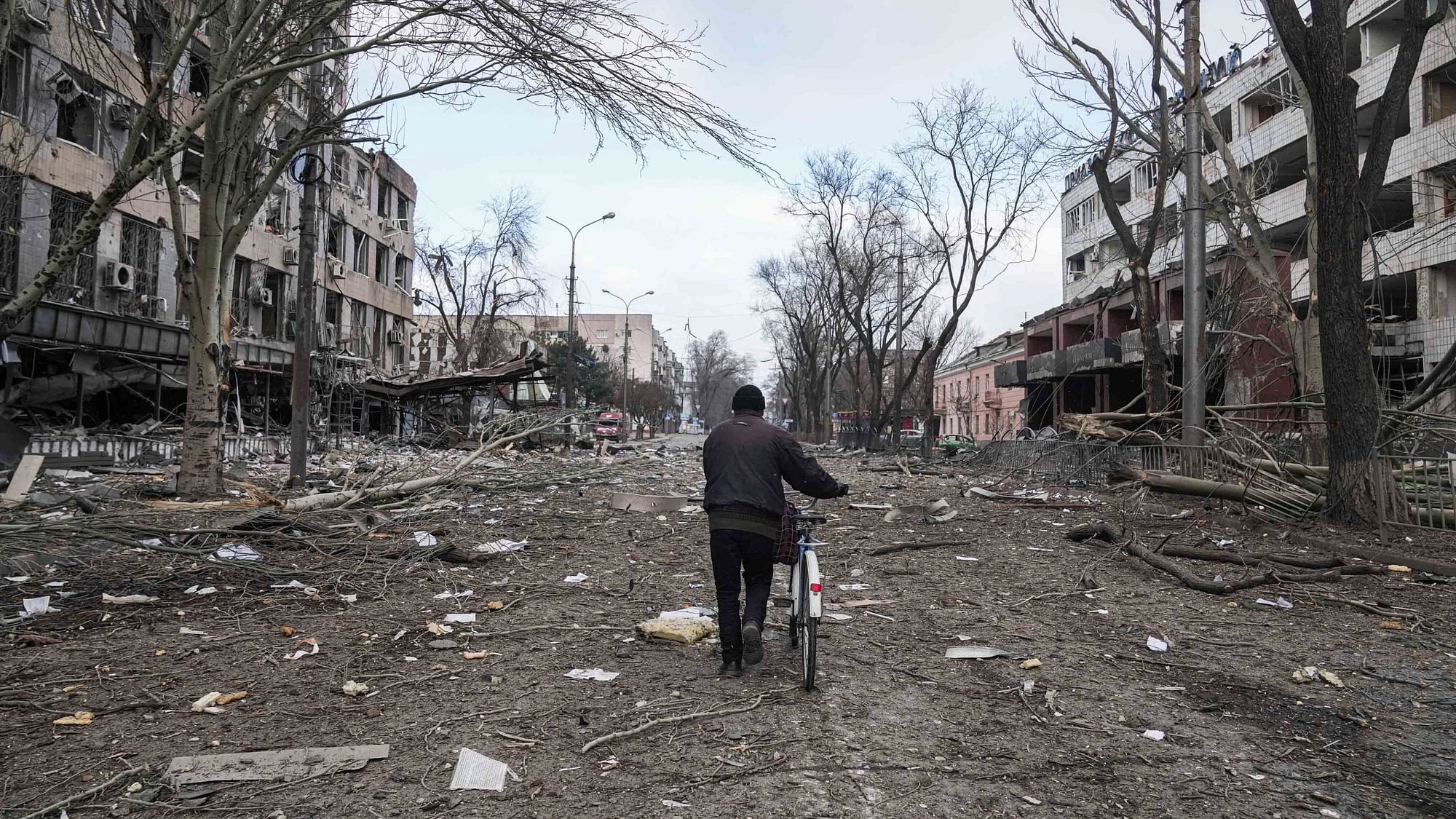<div class="paragraphs"><p>A man walks with a bicycle in a street damaged by shelling in Mariupol, Ukraine, Thursday, 10 March.</p></div>