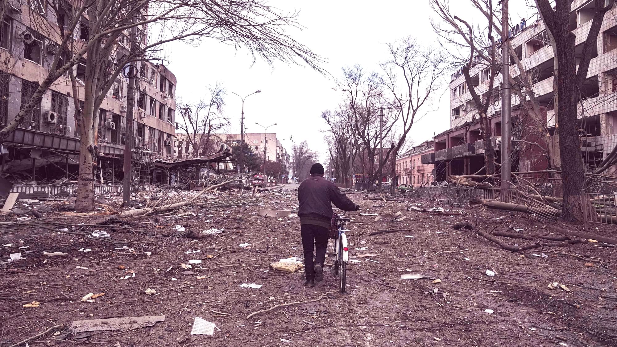 <div class="paragraphs"><p>A man walks with a bicycle in a street damaged by shelling in Mariupol, Ukraine, Thursday, 10 March. Photo for representation.&nbsp;</p></div>