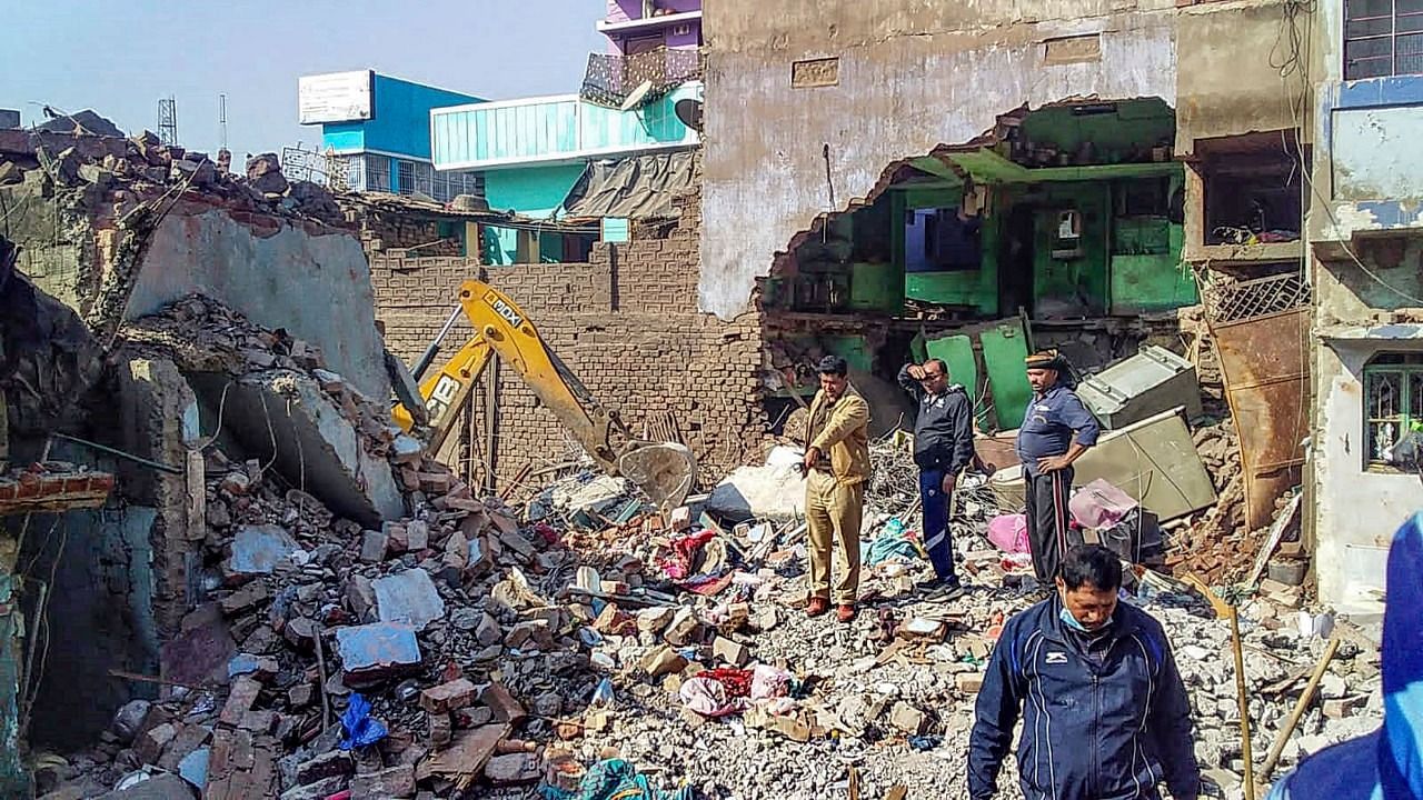 <div class="paragraphs"><p>Bhagalpur: A volunteer near a damaged house after a massive explosion ripped through a three-storey building in Bhagalpur district on Thursday.</p></div>