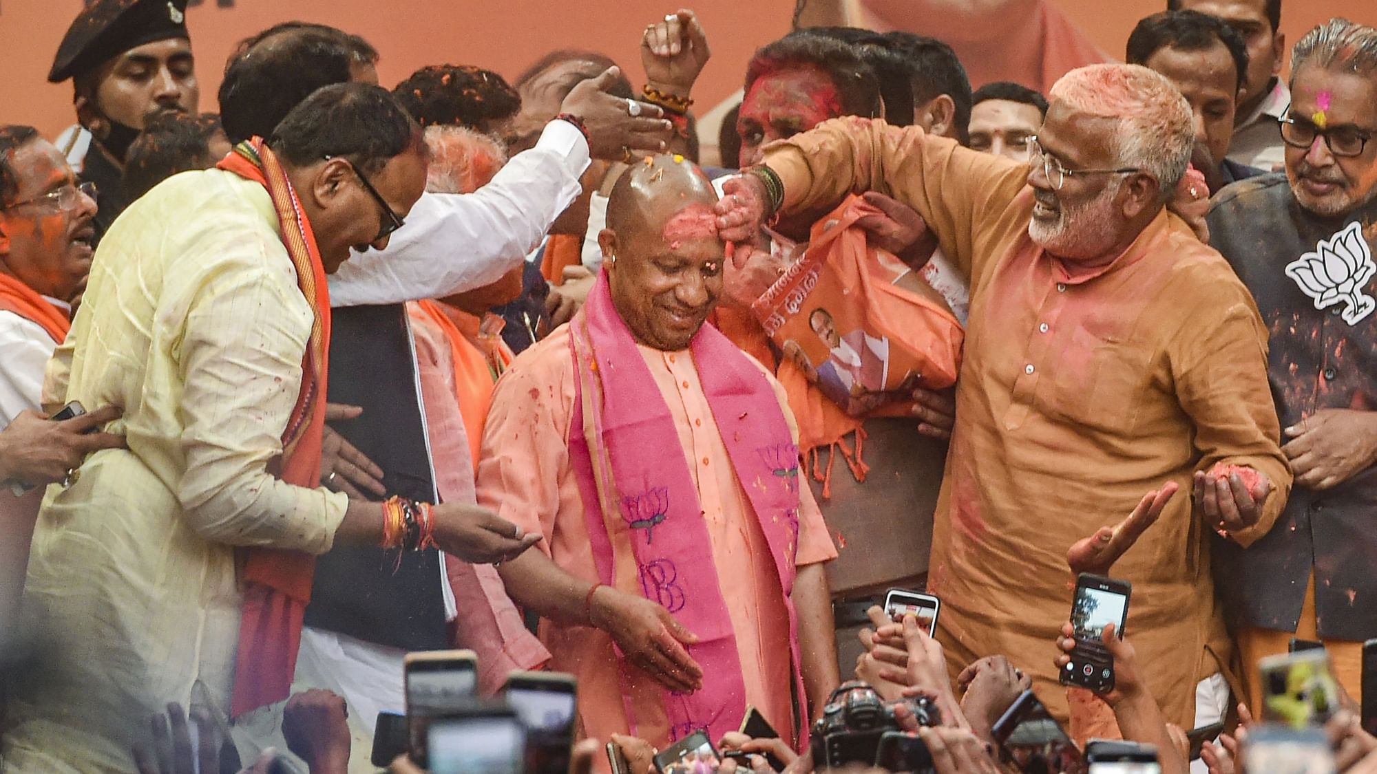 <div class="paragraphs"><p>BJP workers apply gulal on UP Chief Minister Yogi Adityanath after his victory in UP Assembly polls during a celebration at the party office, in Lucknow on Thursday.</p></div>