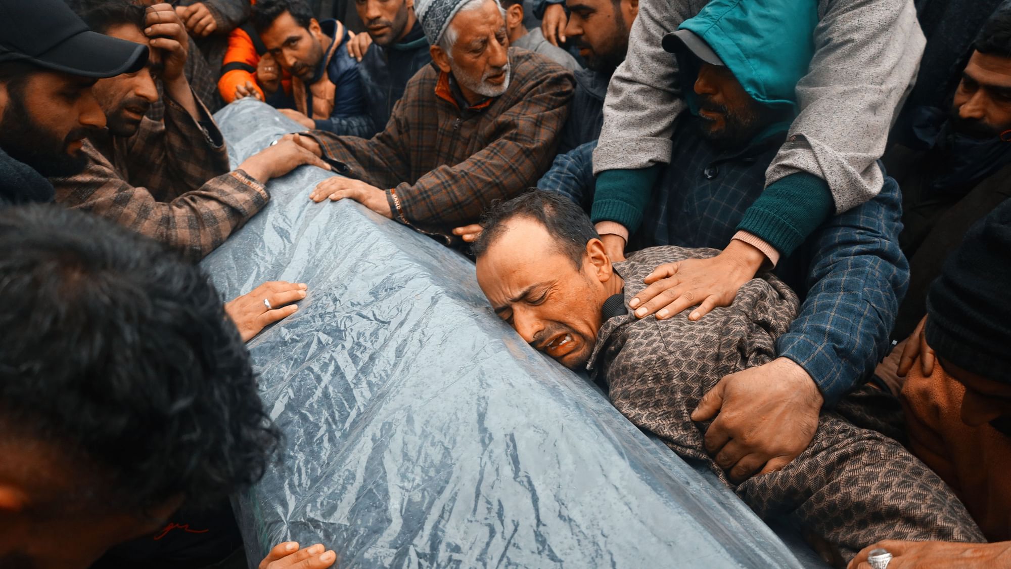 <div class="paragraphs"><p>Rafia Nazir's brother throws himself upon her coffin, exhausted from grief.</p></div>