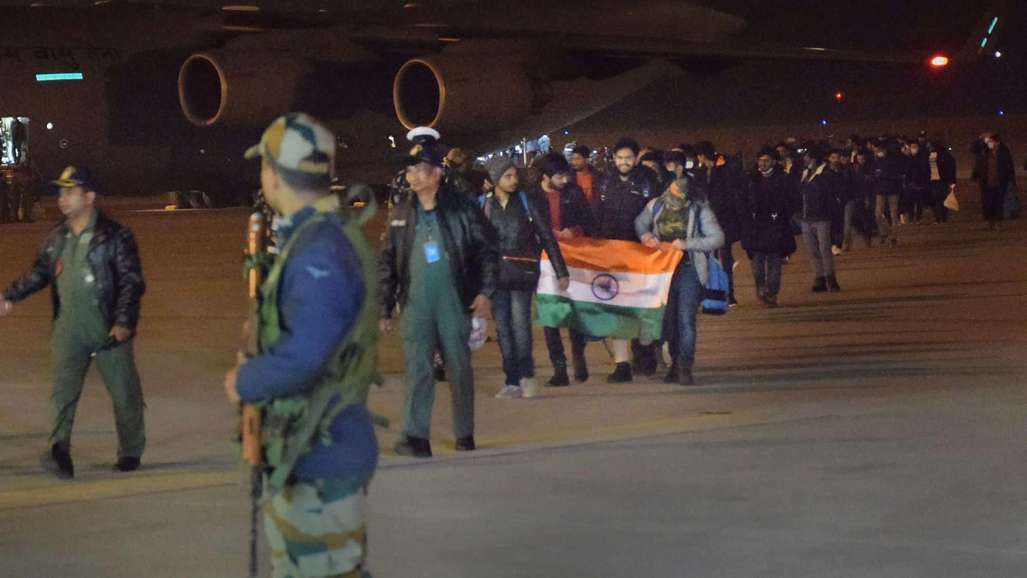 <div class="paragraphs"><p>Indian nationals, evacuated from crisis-hit Ukraine, holding the national flag arrive at the Hindon Air Force Station, in Ghaziaba</p></div>