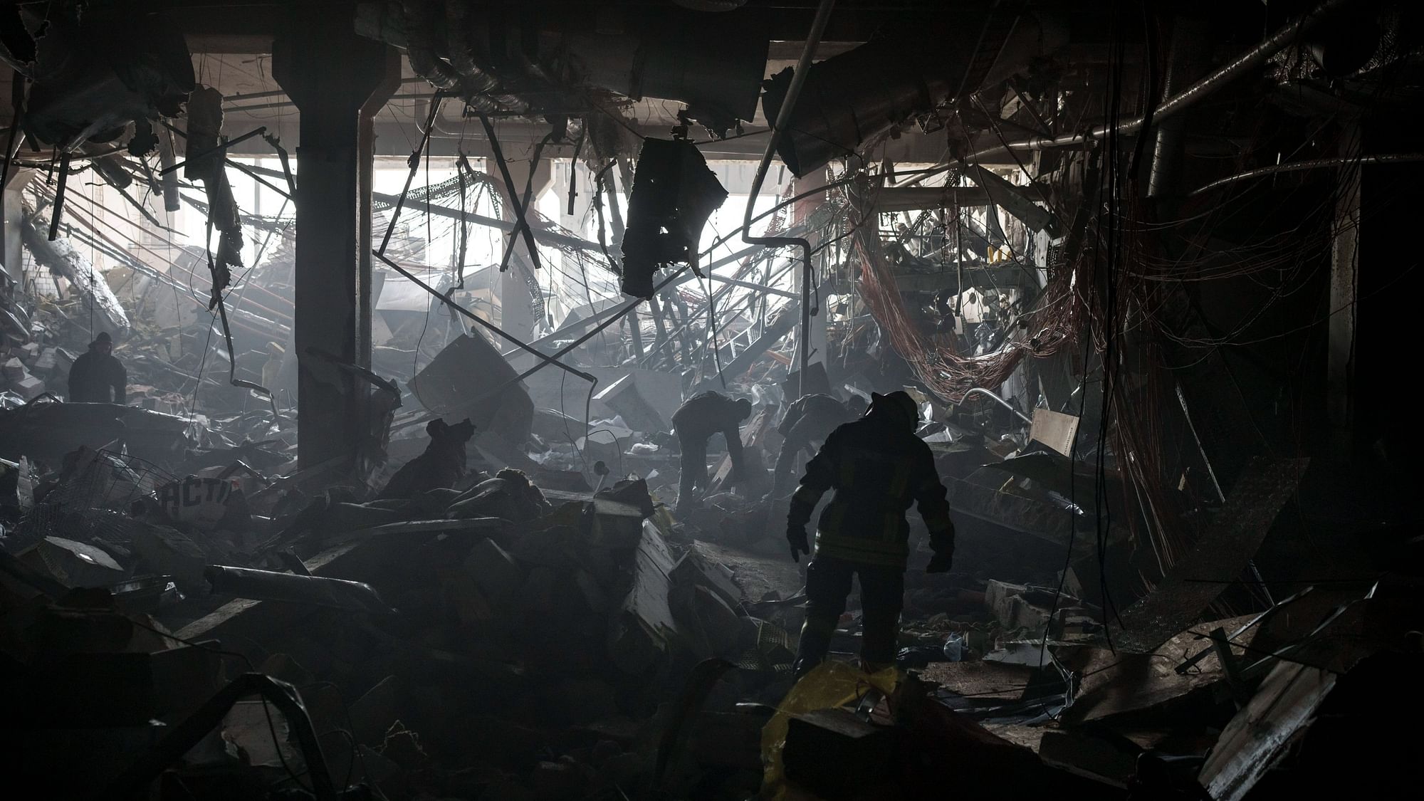 <div class="paragraphs"><p> Ukrainian firefighters and service personnel search for people under debris inside a shopping centre after bombing in Kyiv, Ukraine.</p></div>