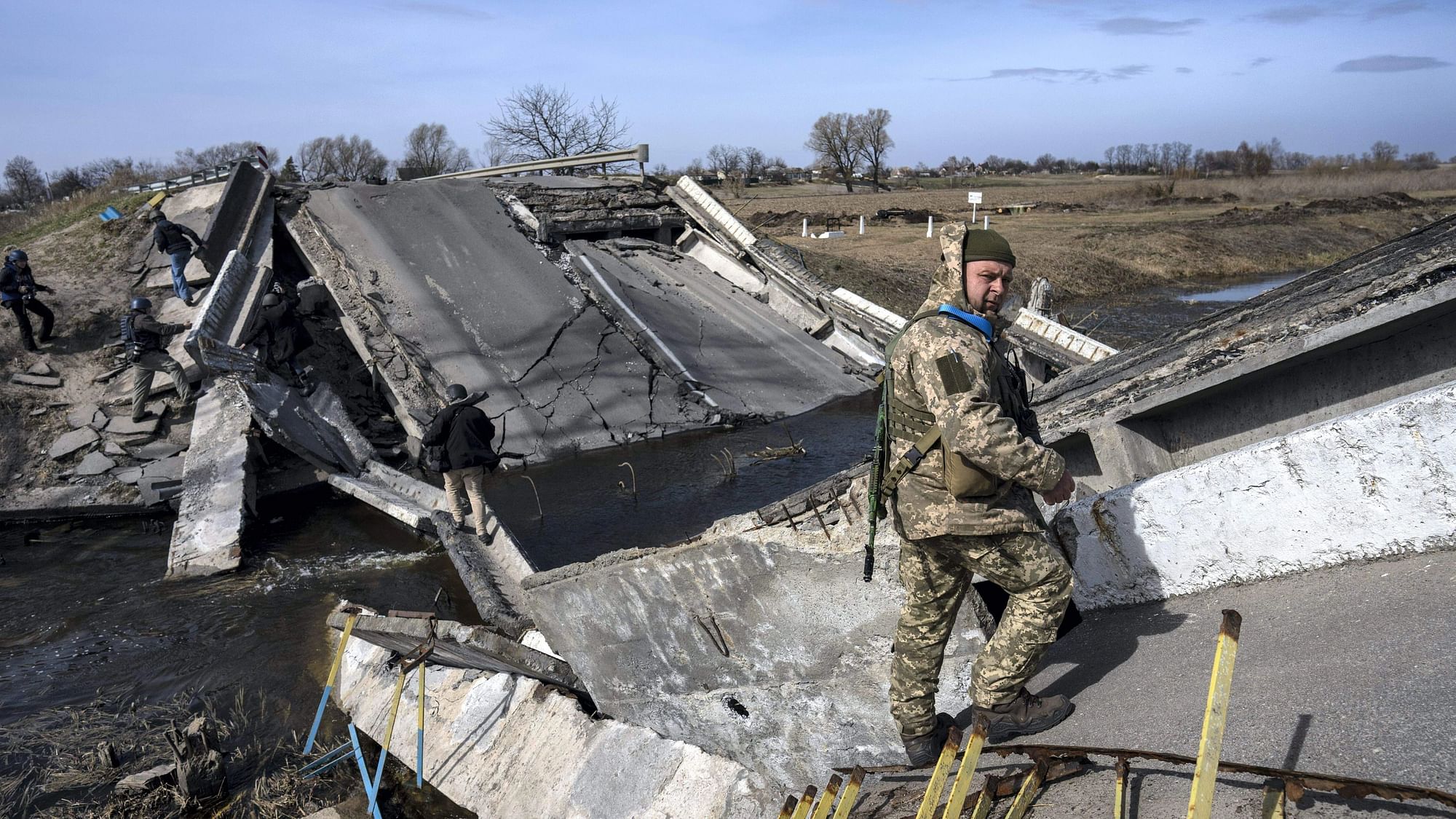 <div class="paragraphs"><p>A soldier stands on a bridge destroyed by the Ukrainian army to prevent the passage of Russian tanks near Brovary, in the outskirts of Kyiv, Ukraine, Monday, March 28, 2022.</p></div>