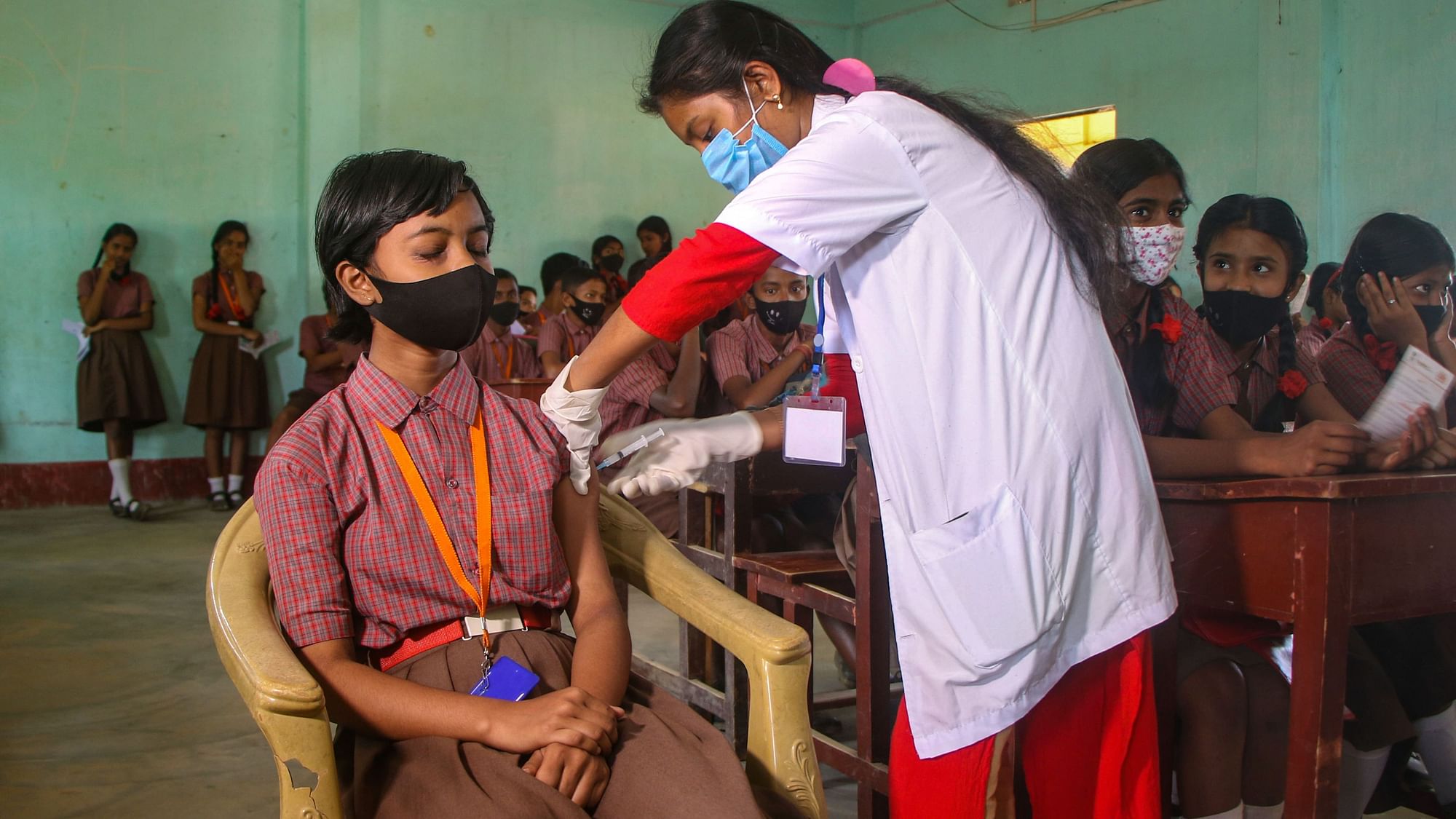 <div class="paragraphs"><p>A healthcare worker administers a dose of the COVID-19 preventive vaccine to a student, at a school on the outskirts of Agartala. Vaccination for children in the age group of 12 to 14 years began on Wednesday.</p></div>