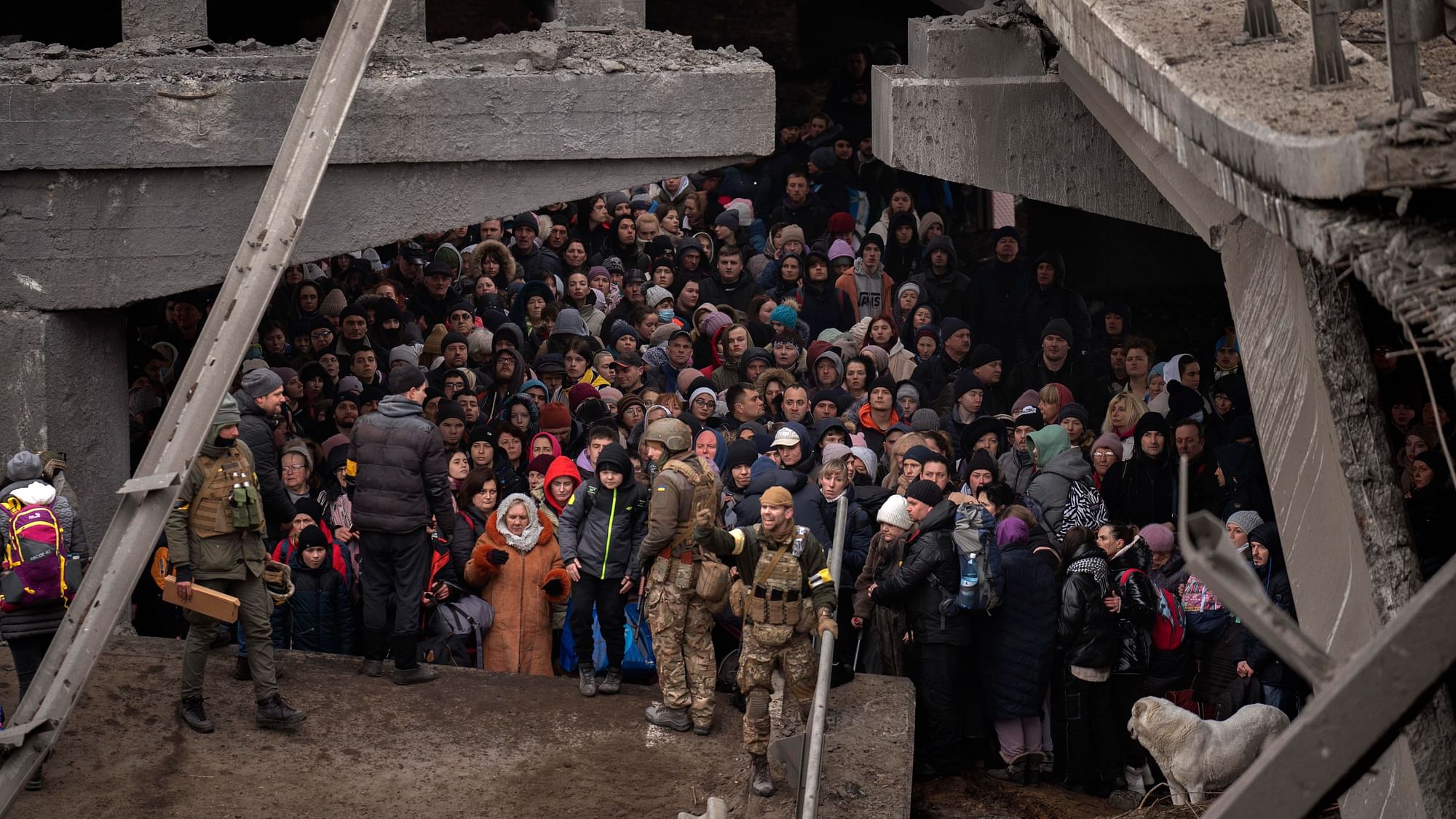 <div class="paragraphs"><p>Ukrainians crowd under a destroyed bridge as they try to flee by crossing the Irpin river on the outskirts of Kyiv, Ukraine, on Saturday, 5 March.</p></div>