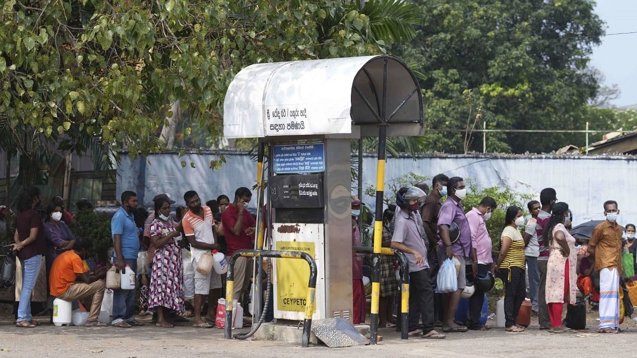 <div class="paragraphs"><p>Colombo: Sri Lankans wait in a queue to buy kerosene oil in Colombo, Sri Lanka, Friday, March 25, 2022. Earlier this month, Sri Lanka's president requested people's support by limiting electricity and fuel consumption to cope with the worst economic crisis the country has seen. </p></div>