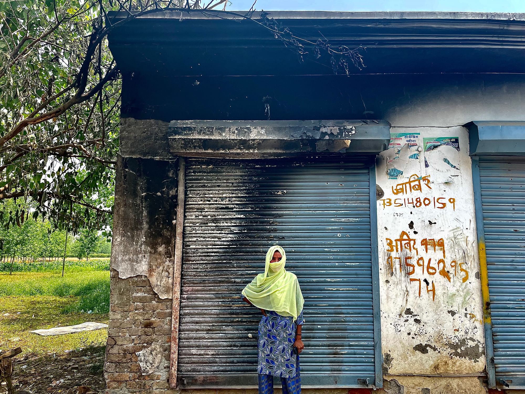 <div class="paragraphs"><p>Reshma (30) stands in front of her burnt shop.</p></div>