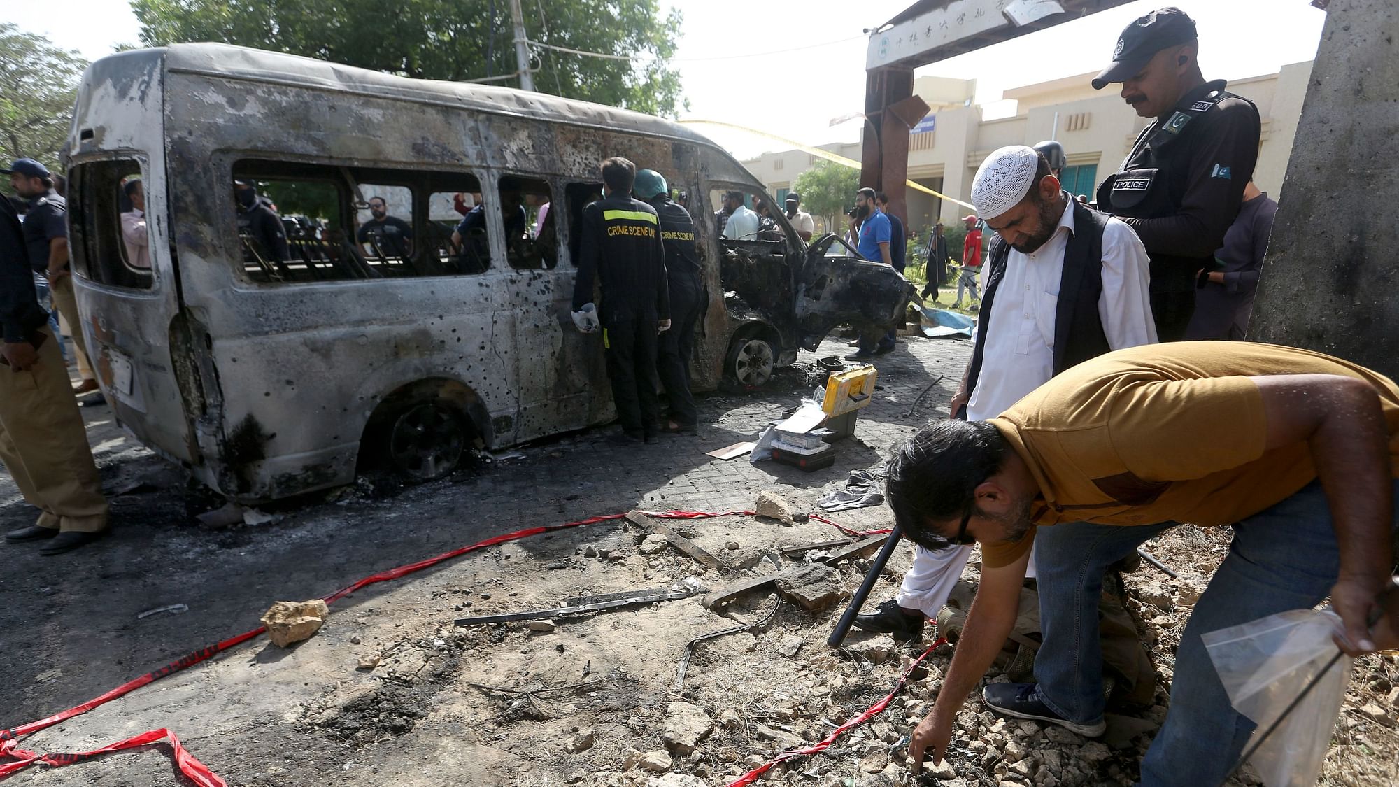 <div class="paragraphs"><p>Karachi: Pakistani investigators gather evidence at the site of explosion, in Karachi, Pakistan, Tuesday, April 26, 2022. The explosion ripped through a van inside a university campus in southern Pakistan on Tuesday, killing several people including Chinese nationals and their Pakistani driver, officials said.<br></p></div>