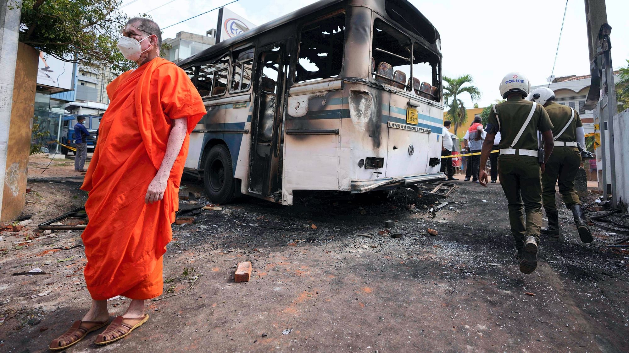 <div class="paragraphs"><p>A Sri Lankan Buddhist monk, supporter of president Gotabaya Rajapaksa, inspects debris created by overnight clashes between protesters and police near the Sri Lankan Presidents private residence on the outskirts of Colombo, Sri Lanka, Friday, April 1, 2022. </p></div>