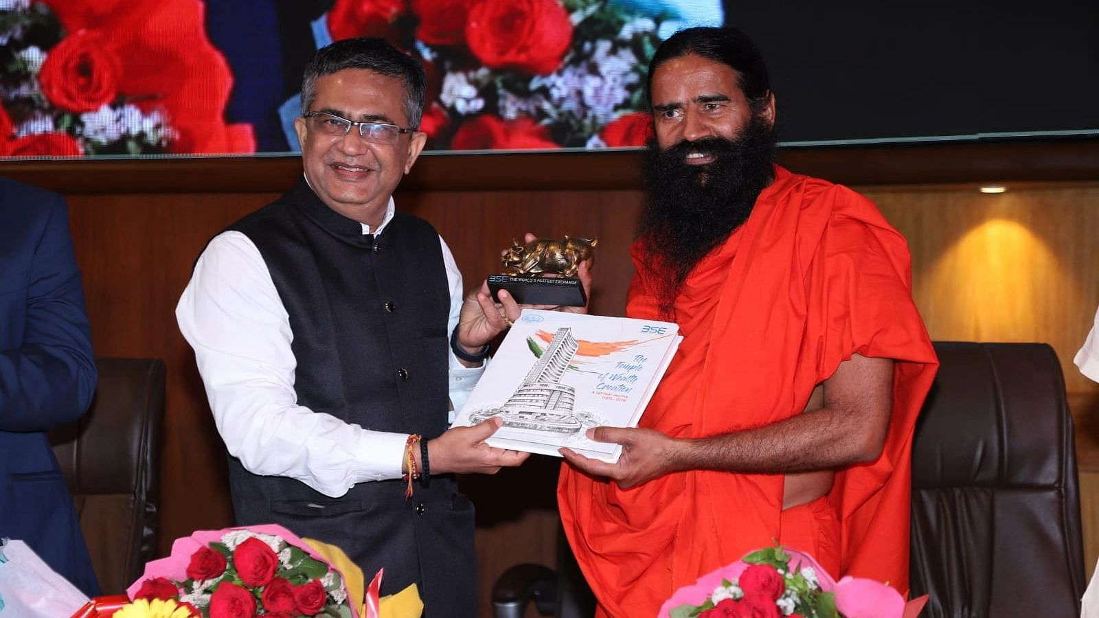 <div class="paragraphs"><p>Baba Ramdev with BSE CEO Ashish Chauhan at the listing ceremony of Ruchi Soya.&nbsp;</p></div>