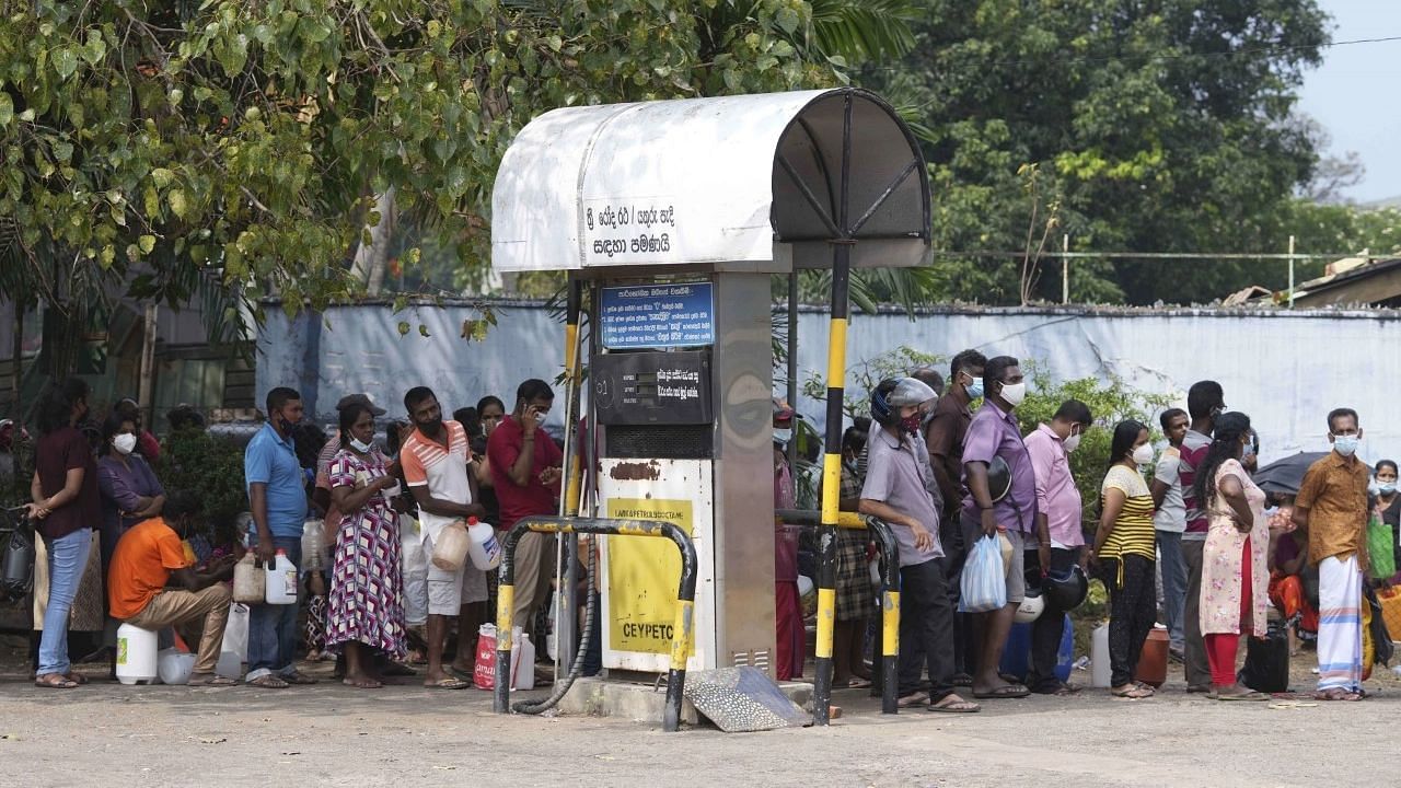 <div class="paragraphs"><p>Sri Lankans waiting in a queue to buy kerosene oil in March this year.&nbsp;&nbsp;</p></div>