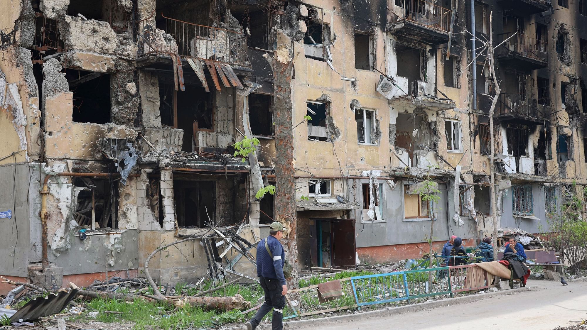<div class="paragraphs"><p>A man walks past a destroyed apartment building in Mariupol, in territory under the government of the Donetsk People's Republic, eastern Ukraine, Wednesday, 4 May.</p></div>