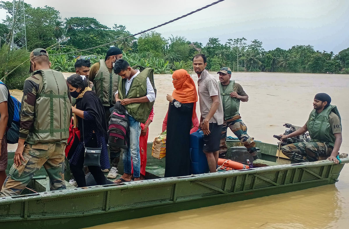 <div class="paragraphs"><p>Army personnel shift flood-affected villagers to a safe place in Hojai district of Assam on 18 May.</p></div>