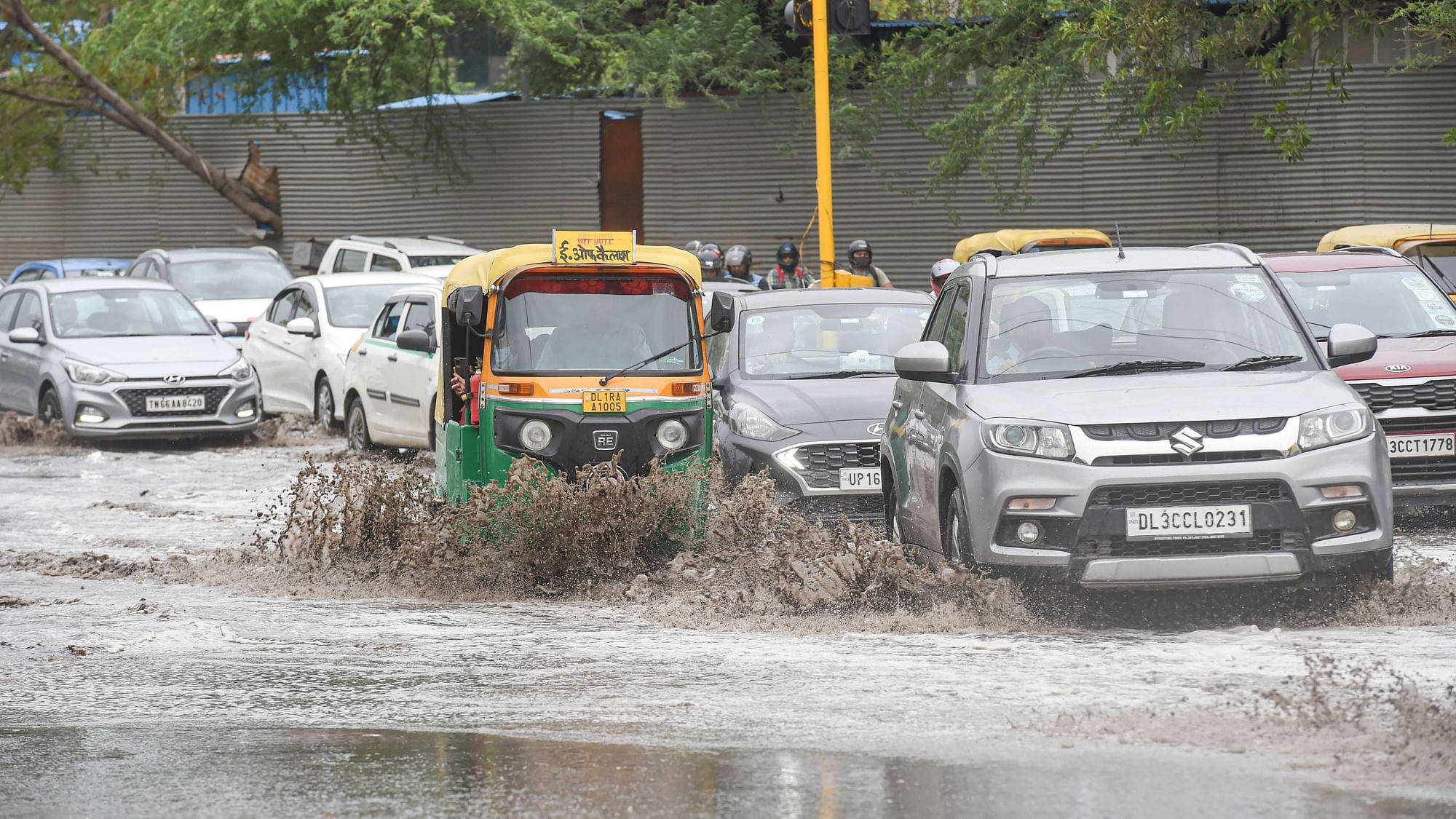 <div class="paragraphs"><p>Vehicles move through a waterlogged area following heavy rain, at Lodhi Road in New Delhi on 23 May.</p></div>