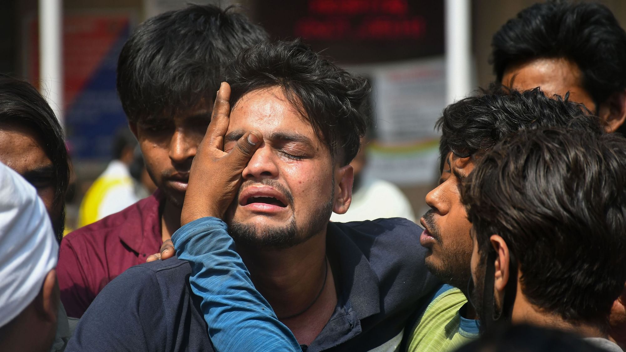 <div class="paragraphs"><p>Family members of the missing people who are unsure about their whereabouts react after a massive fire at an office building near the Mundka Metro Station, outside Sanjay Gandhi Memorial Hospital in New Delhi, Saturday, May 14, 2022.</p></div>