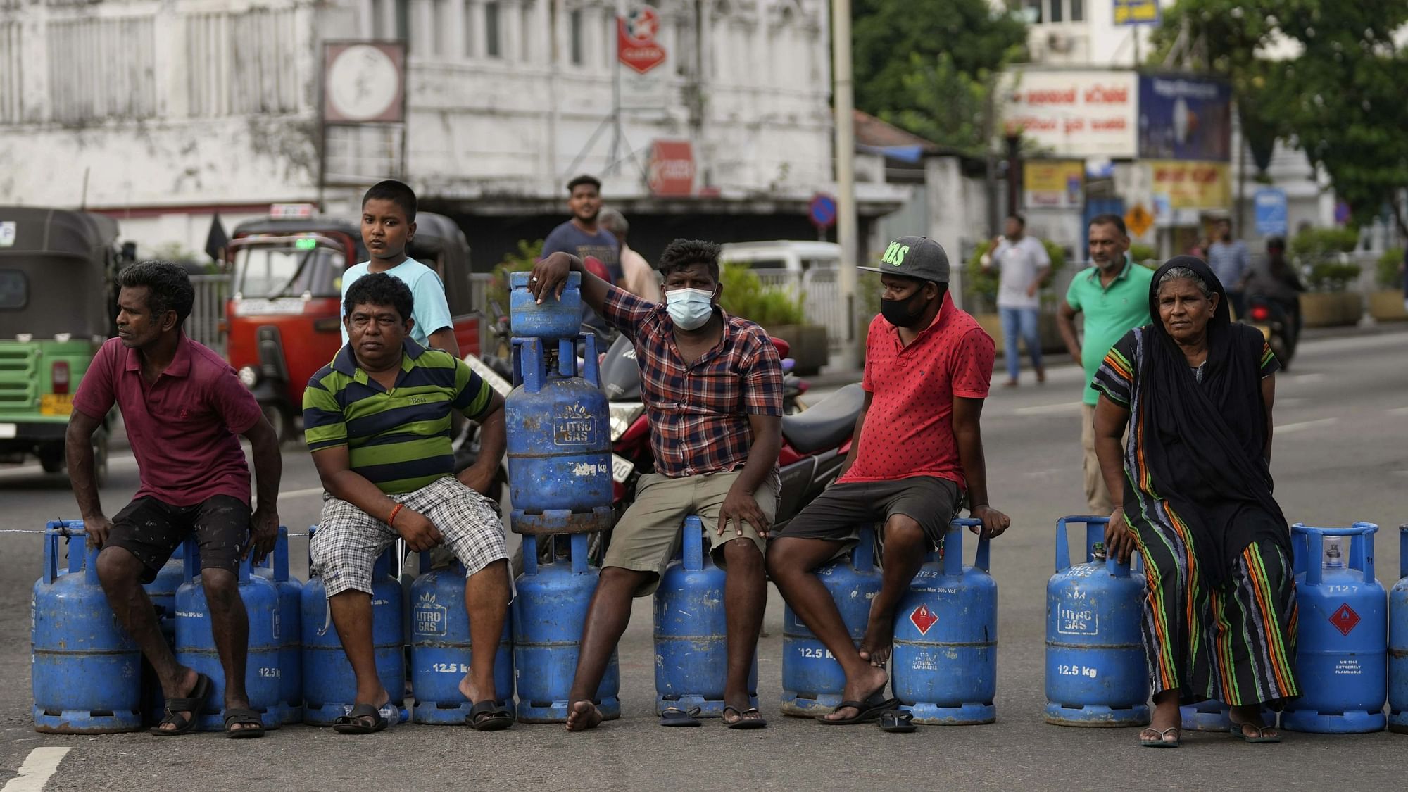 <div class="paragraphs"><p>Sri Lankans block an intersection demanding cooking gas cylinders in Colombo on 7 May. </p></div>