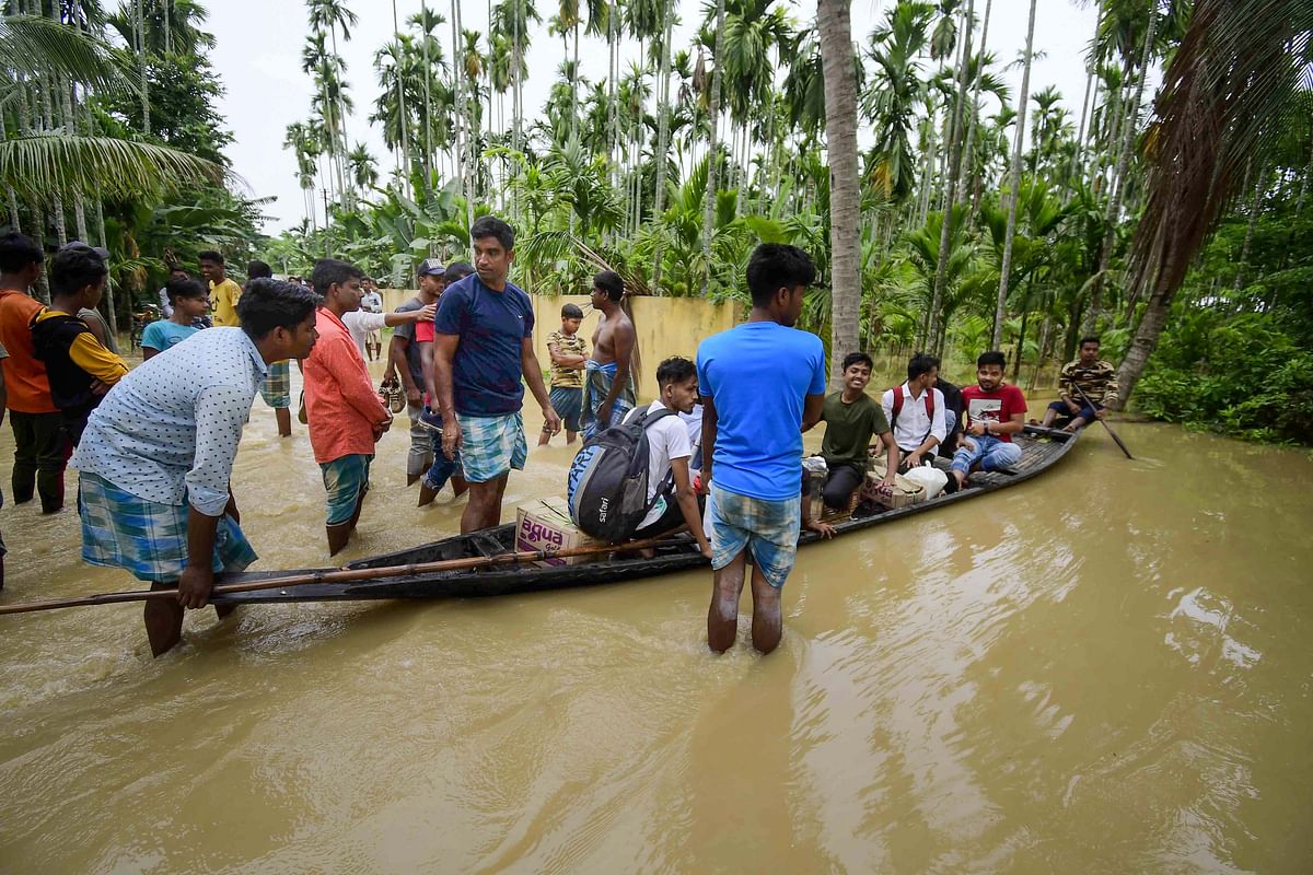 <div class="paragraphs"><p>Villagers wade through a flooded area of Bakula Guri village using a boat, in the Nagaon district on 15 May.</p></div>