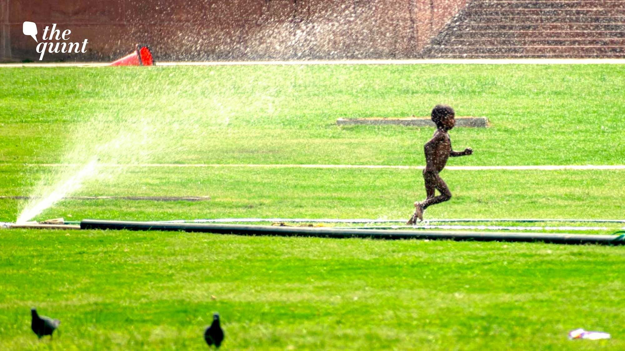 <div class="paragraphs"><p>A little boy enjoying water spray from a leaking pipe in front of Rashtrapati Bhavan.</p></div>