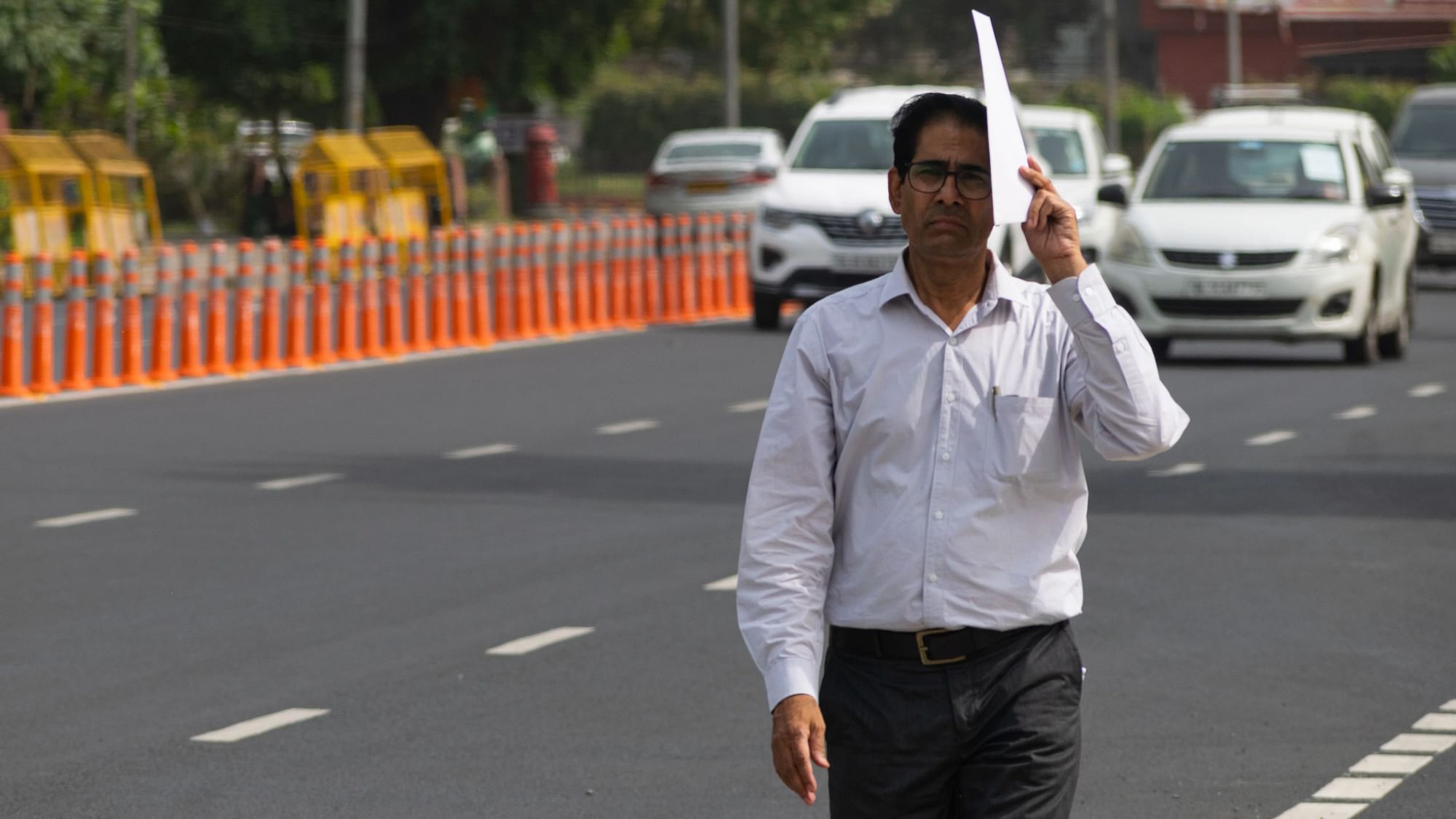 <div class="paragraphs"><p>A section officer in Ministry of Labour and Employment protecting himself from scorching heat in New Delhi.</p></div>