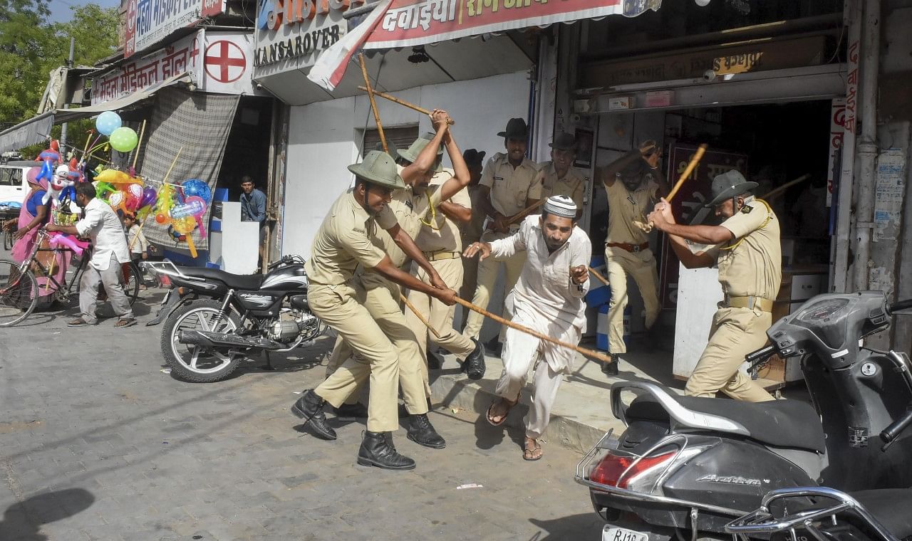 <div class="paragraphs"><p>Police lathi-charge a man after clashes broke out between two communities on Eid al-Fitr, in the Jalori Gate area.</p></div>