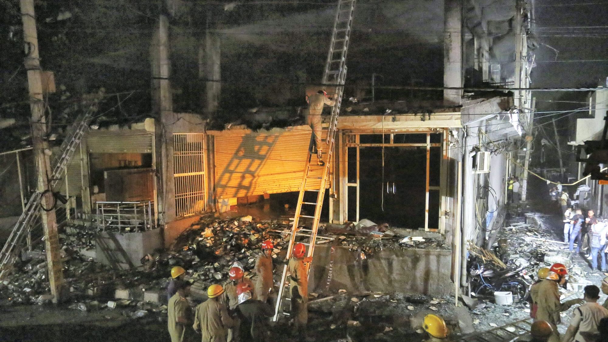 <div class="paragraphs"><p>Fire Brigade personnel carry out rescue work after a massive fire broke out at an office building near the Mundka Metro Station, in West Delhi, in the wee hours of Saturday, 14 May.</p></div>
