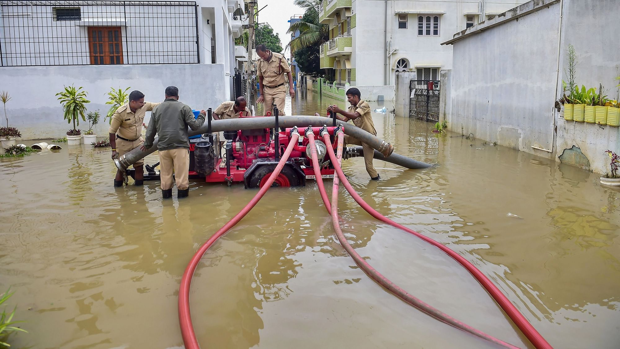 <div class="paragraphs"><p>Fire brigade personnel pump water out of a flooded street in the Horamavu area of Bengaluru on&nbsp; Thursday.</p></div>