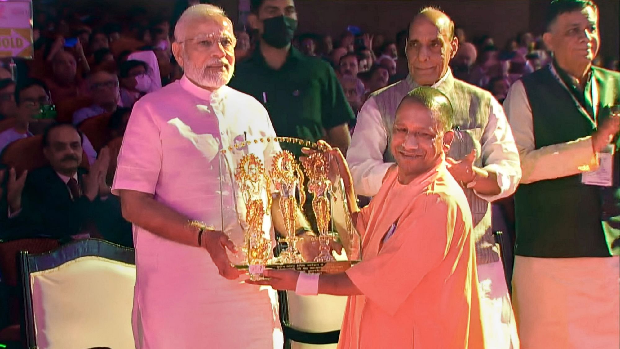 <div class="paragraphs"><p>Prime Minister Narendra Modi being presented a memento by UP CM Yogi Adityanath as Defence Minister Rajnath Singh looks on during the Ground Breaking Ceremony of the UP Investors Summit held in Lucknow on Friday, 3 June. </p></div>