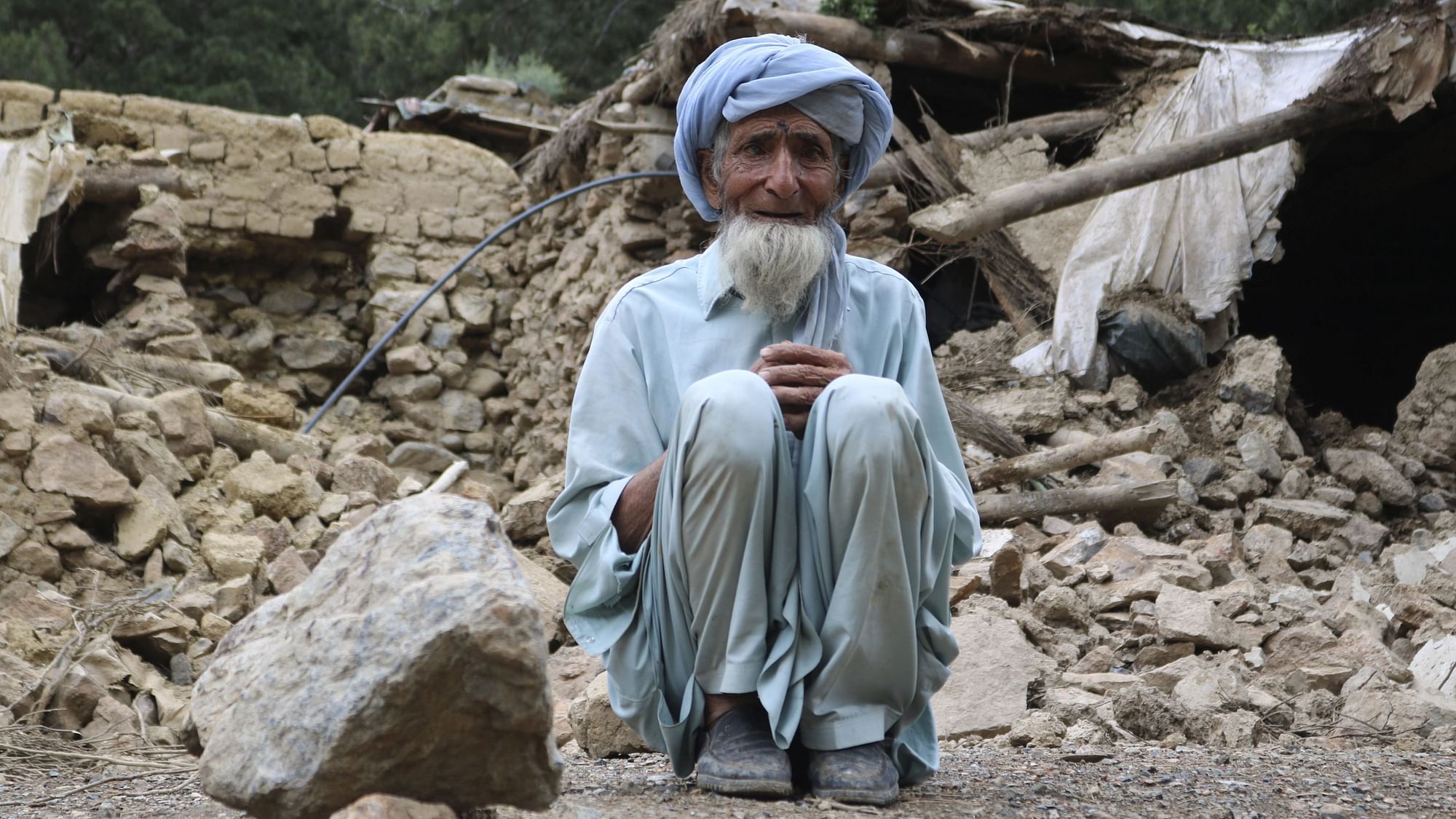 <div class="paragraphs"><p>An Afghan man sits near his house that was destroyed in an earthquake in the Spera district of the southwestern part of Khost Province, Afghanistan, Wednesday, 22 June.</p></div>