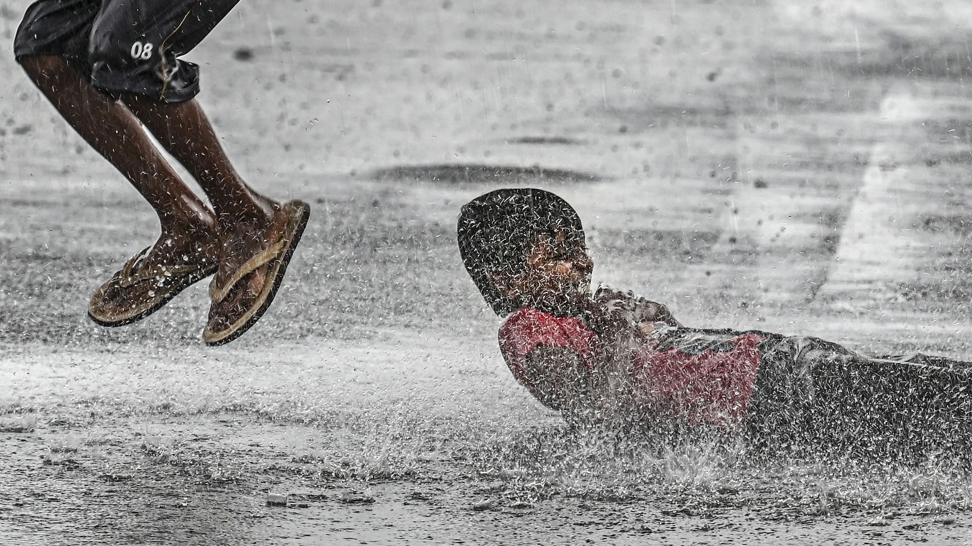 <div class="paragraphs"><p>New Delhi: Boys play on a waterlogged road amid monsoon rains, in New Delhi, on Thursday, 30 June. Delhi is witnessing heavy rain with the onset of monsoon, bringing much-needed relief after days of hot and humid weather.</p></div>