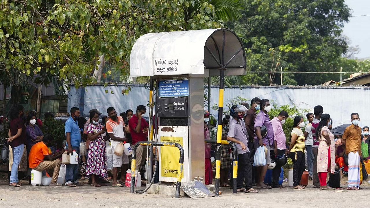 <div class="paragraphs"><p>People wait in a queue to buy kerosene and oil in Colombo, Sri Lanka.</p></div>