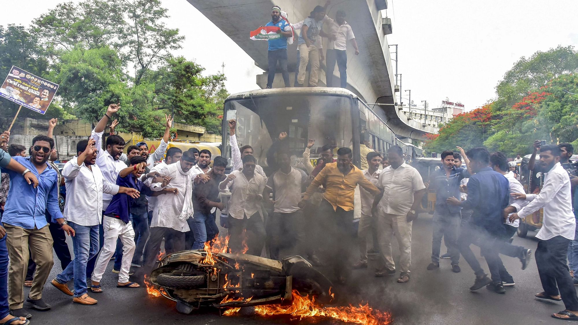 <div class="paragraphs"><p>Congress party workers burn a motorcycle during a protest march.</p></div>