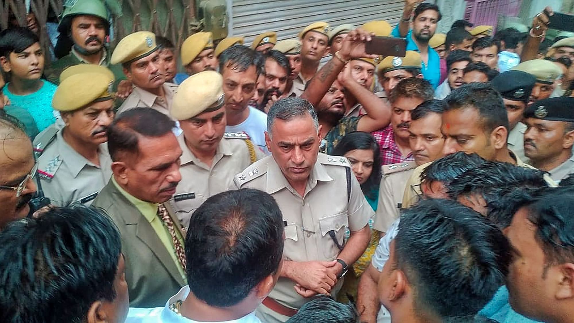 <div class="paragraphs"><p>Cops interact with locals after the murder of Kanhaiya Lal in Udaipur.</p></div>