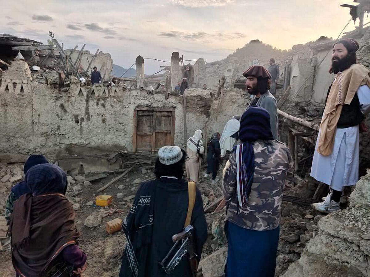 <div class="paragraphs"><p>In this photo released by a set-run news agency Bakhtar, Afghans look at the destruction caused by an earthquake in the province of Paktika, eastern Afghanistan, Wednesday.</p></div>