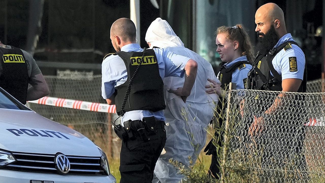 <div class="paragraphs"><p>A person in a white DNA suit being taken away by the police, near the Fields shopping mall after the Copenhagen shooting.</p></div>