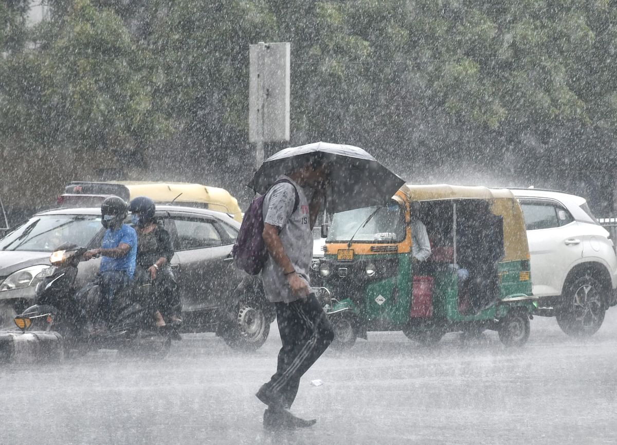 <div class="paragraphs"><p>New Delhi: A pedestrian takes cover from monsoon rain, in New Delhi, Monday, 11 July.</p></div>