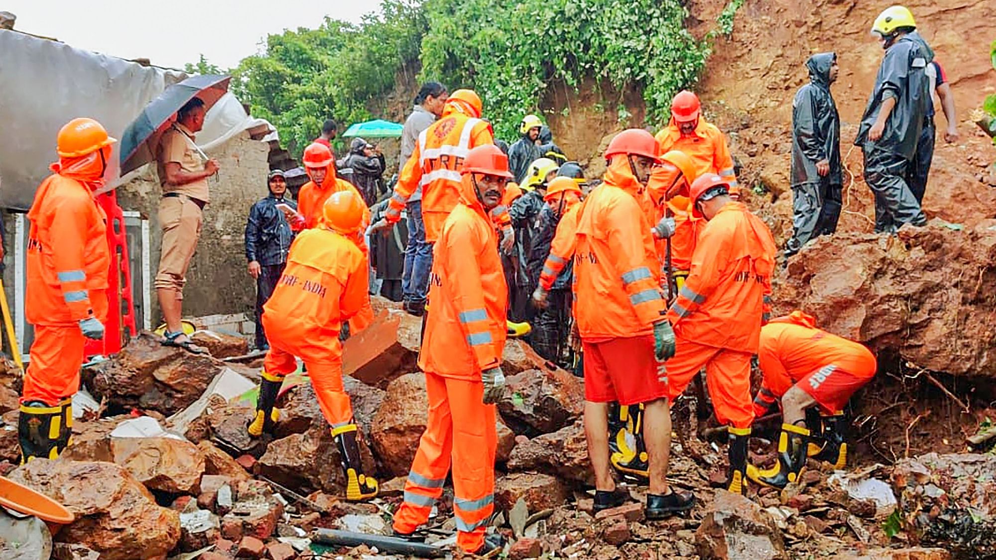 <div class="paragraphs"><p>NDRF and fire services personnel carry out rescue and relief work following a landslide triggered by heavy monsoon rains, in Vasai near Mumbai, Wednesday, 13 July.</p></div>
