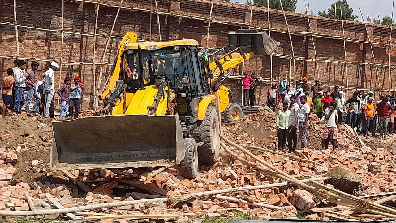 <div class="paragraphs"><p>Debris being cleared after wall collapsed in Alipur Delhi.</p></div>