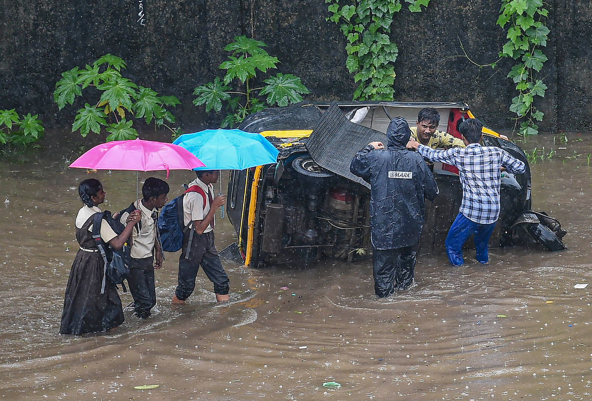 Visuals from Mumbai show heavy inundation in Sion and Andheri areas, with commuters wading through the streets.
