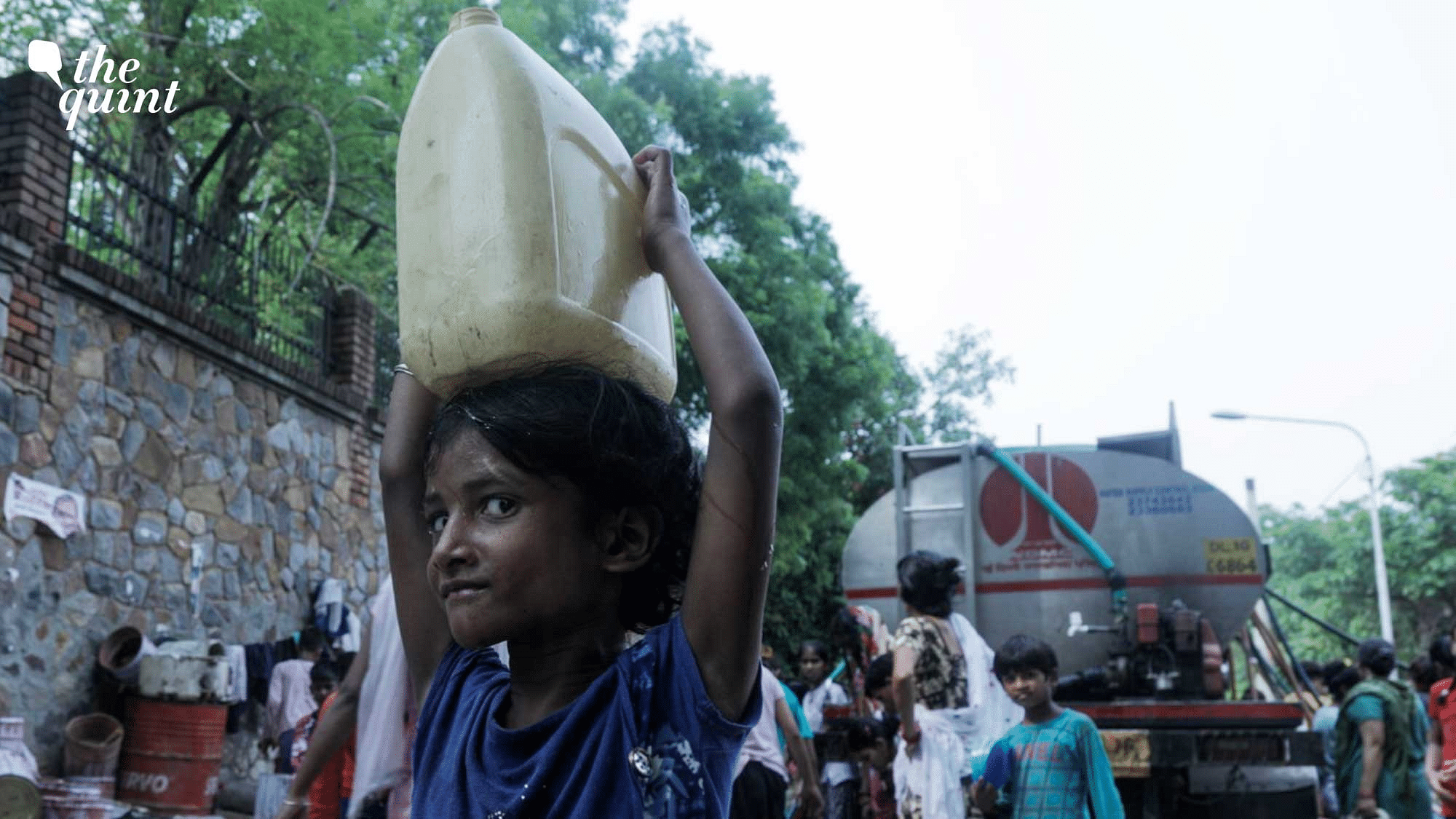 <div class="paragraphs"><p>A little girl carrying a&nbsp; can of water back home.</p></div>