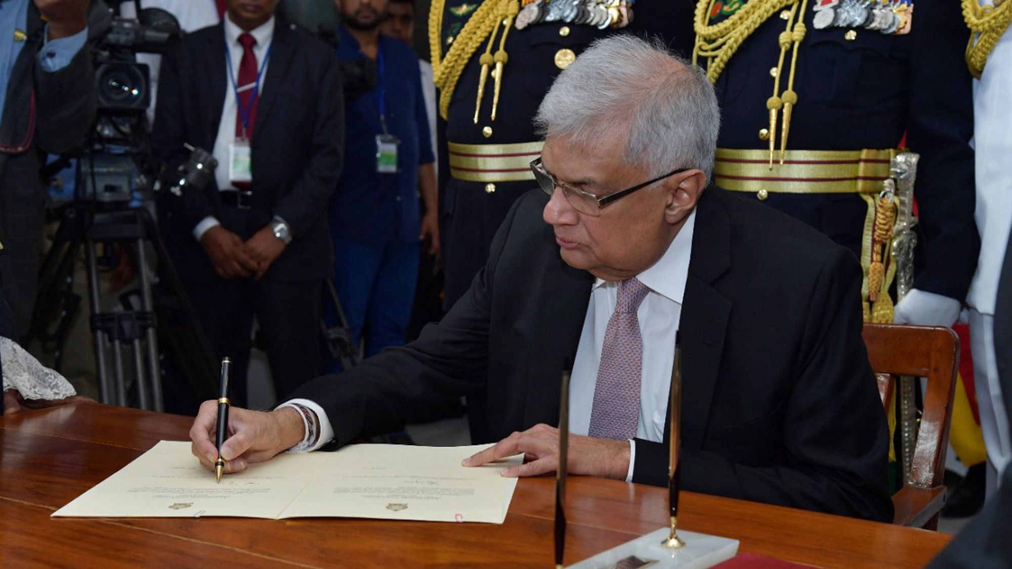 <div class="paragraphs"><p>Sri Lanka's newly elected president Ranil Wickremesinghe, signs after taking oath during his swearing in ceremony in Colombo.</p></div>