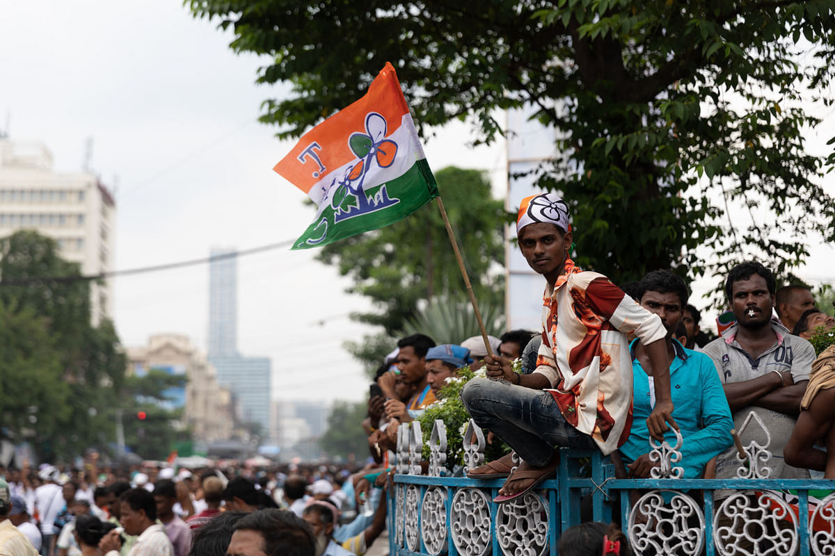 <div class="paragraphs"><p>TMC worker sitting on the divider waiting for the rally to start</p></div>