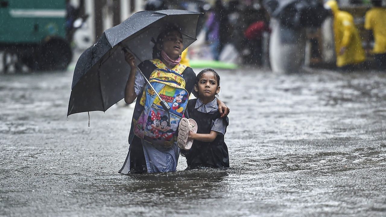 <div class="paragraphs"><p>Mumbai: Schoolchildren wade through a flooded street following heavy monsoon rains, in Mumbai, on Tuesday, 5 July 2022. </p></div>