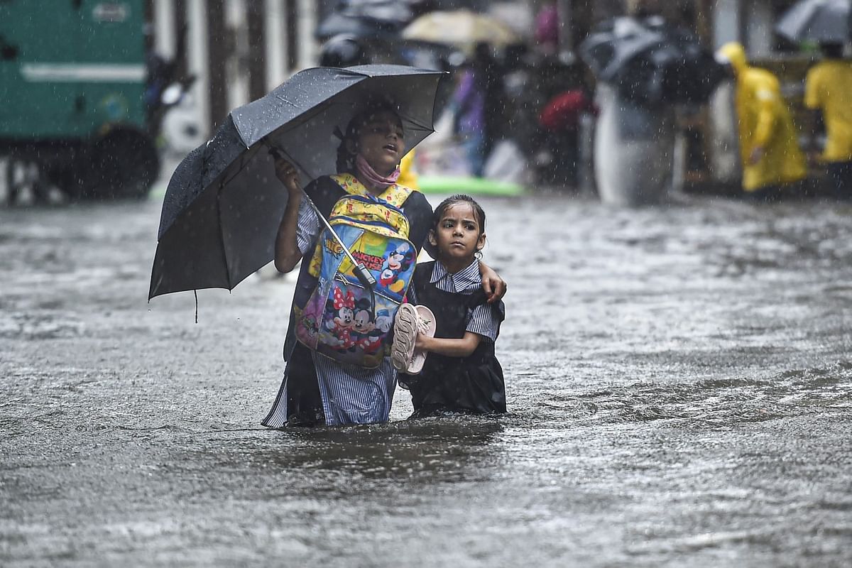 Visuals from Mumbai show heavy inundation in Sion and Andheri areas, with commuters wading through the streets.