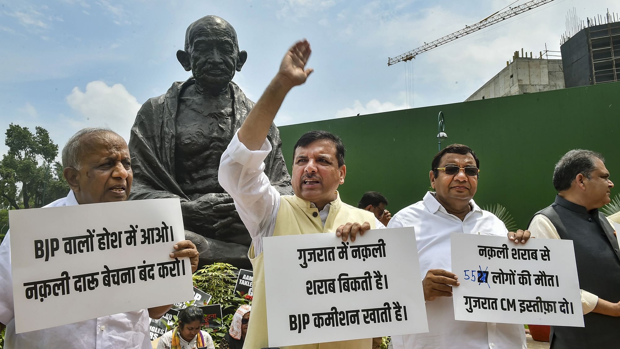 <div class="paragraphs"><p>AAP MPs Sanjay Singh stages a protest over the Gujarat hooch tragedy near the Gandhi statue during the ongoing Monsoon Session of Parliament.</p></div>